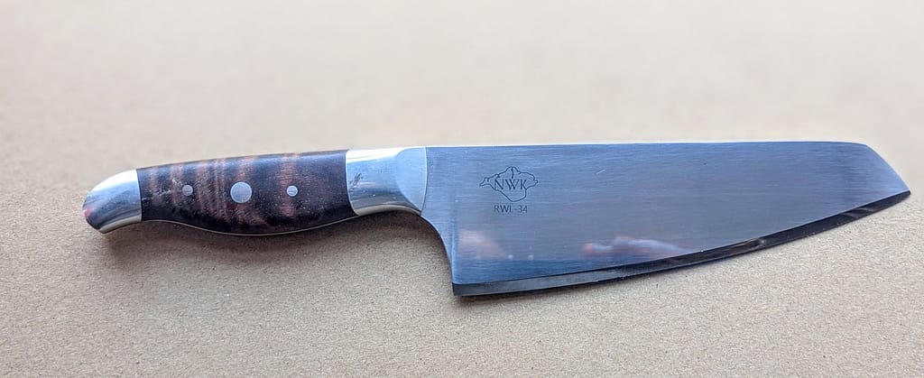 Handmade custom chef knife in RWL34. currly narra and 316 stainless steel